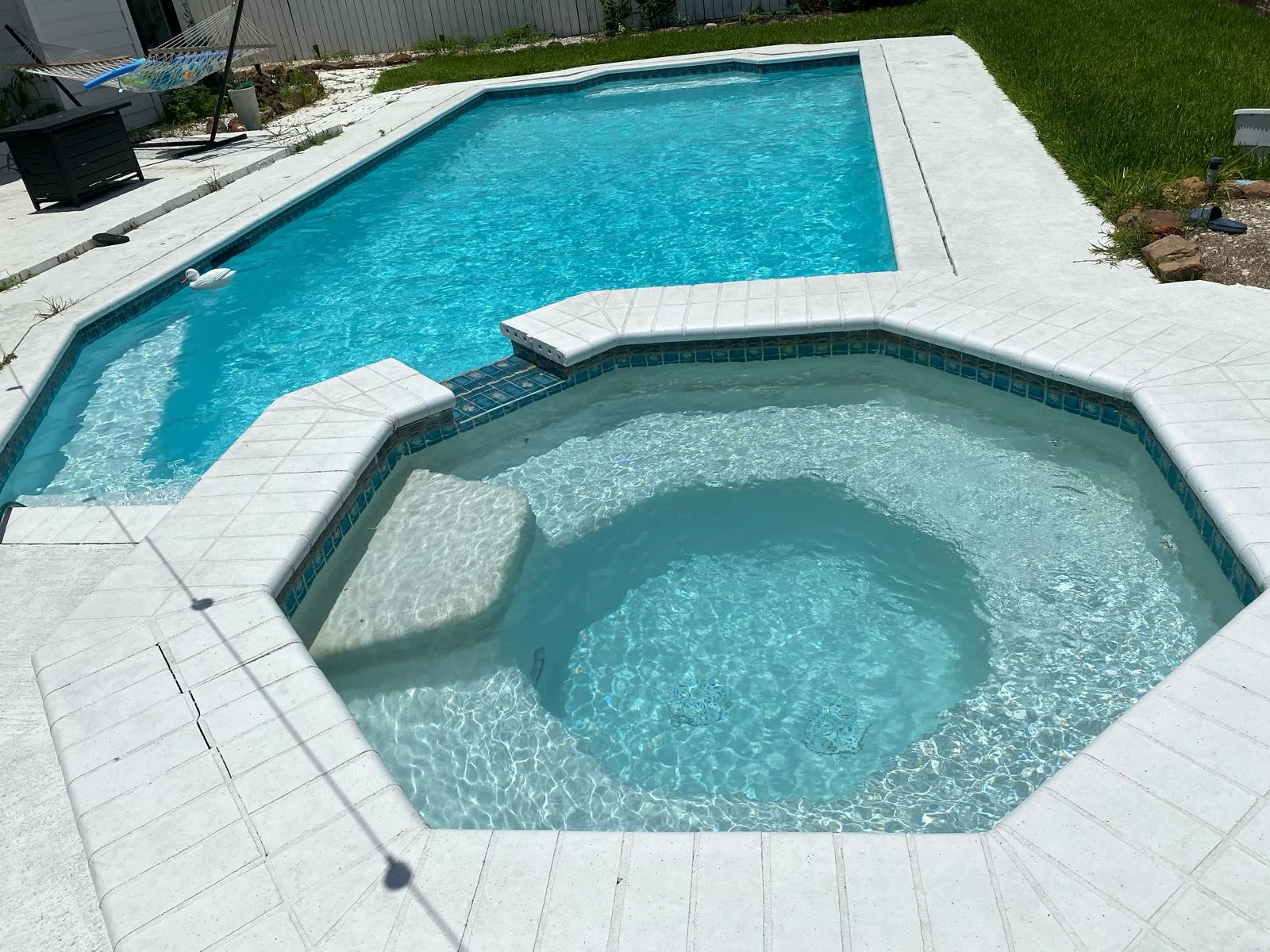 Clean rectangular pool with octagon spa