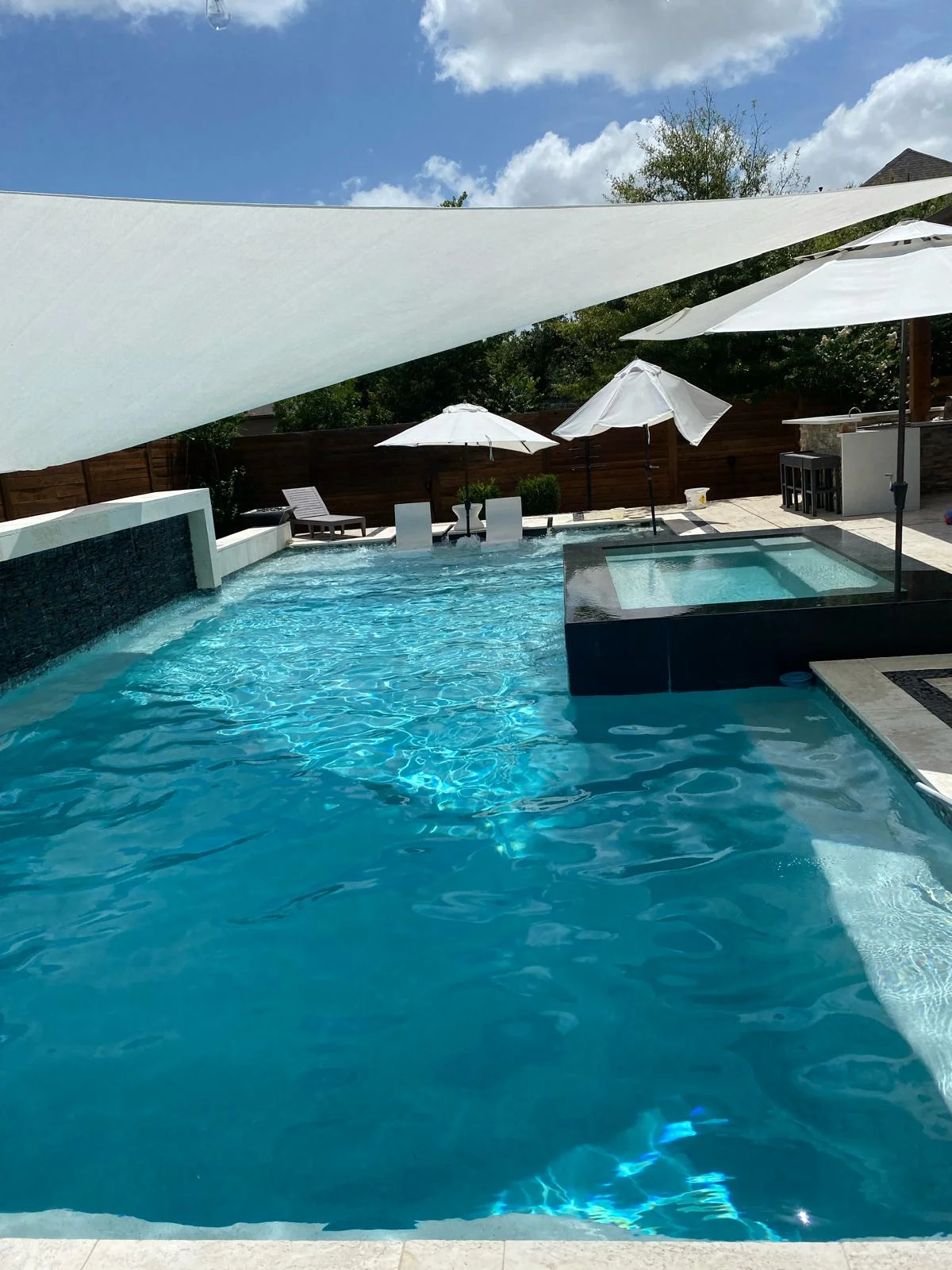 Resort-style pool and spa with shade sails